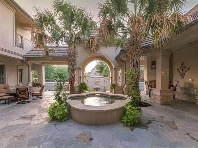 Take a Stroll Through the Lush Central Courtyard with a Fountain