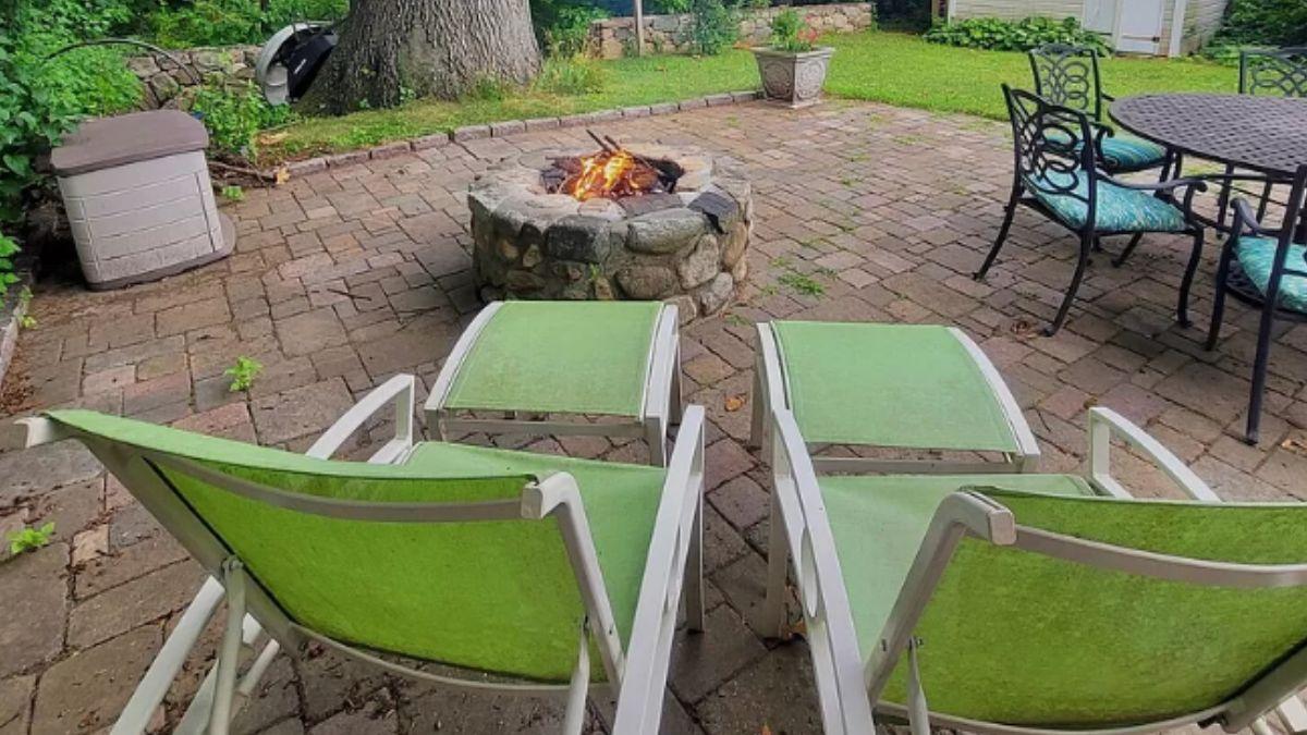 Relax on This Paver Patio with a Stone Fire Pit as the Star