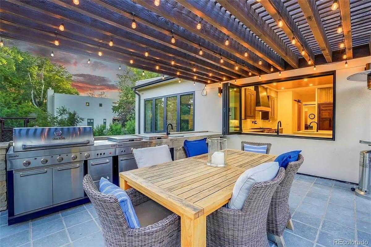 Step Outside to This Outdoor Kitchen with String Lights Under the Pergola