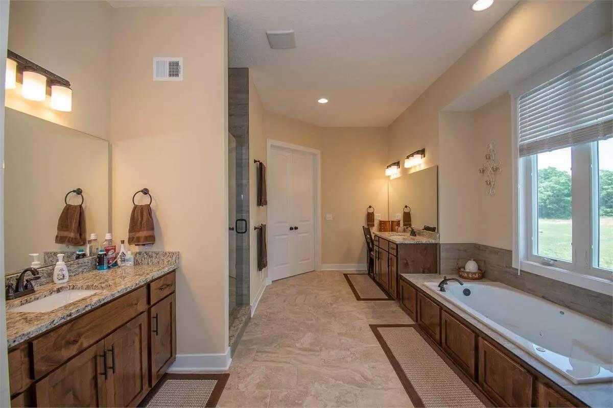 A Luxurious Bathroom with Granite Accents and Dual Vanities