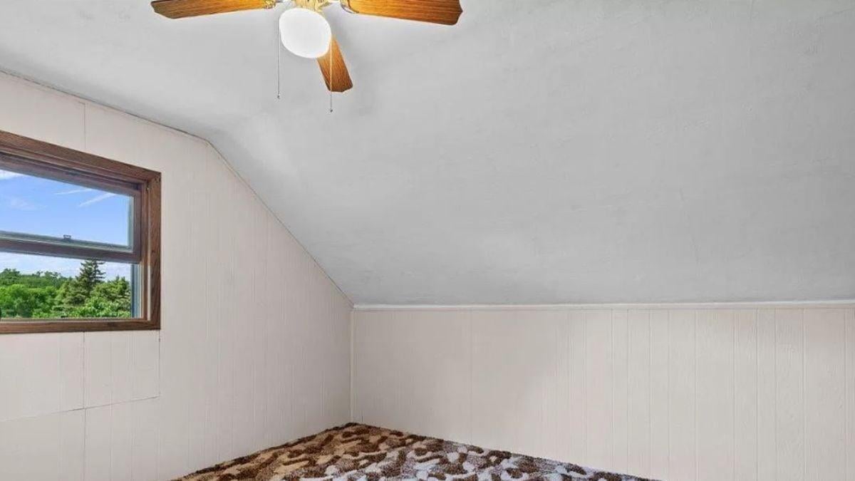 Discover the Retro Charm of This Sloped Ceiling Room with Textured Carpet