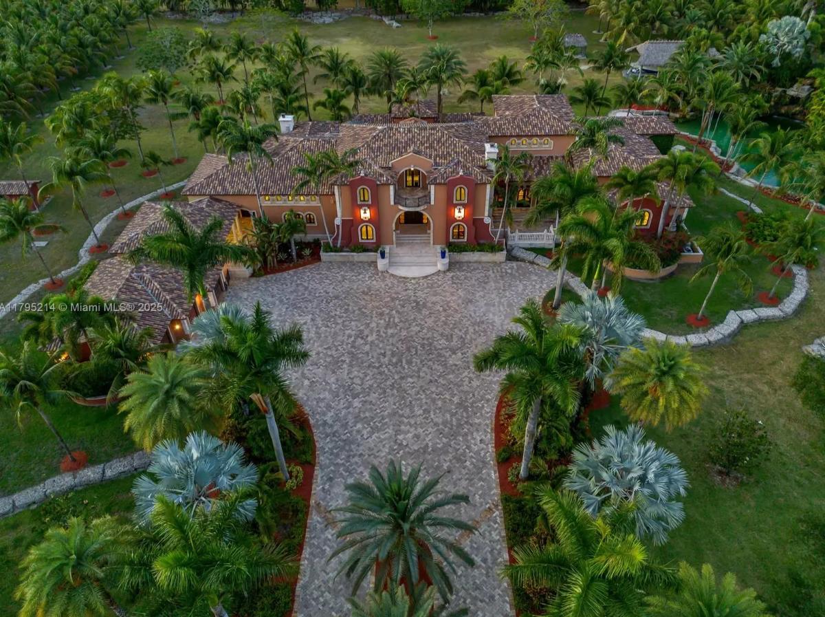 Explore this 11,907 Sq. Ft. South Florida Compound with 800-Bottle Wine Cellar, Grotto Pool, and Coconut Palm Grove in Homestead, FL