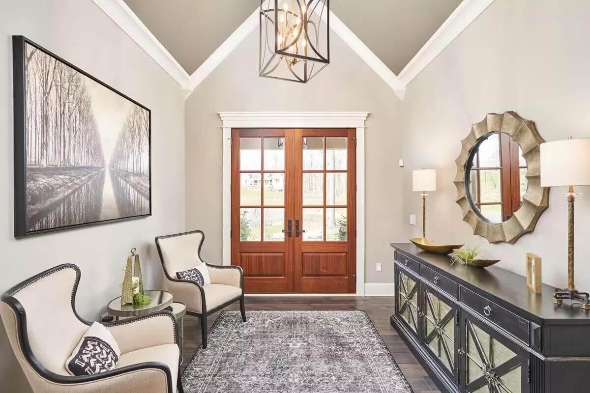 Elegant Entryway Featuring a Vaulted Ceiling and Classic Details