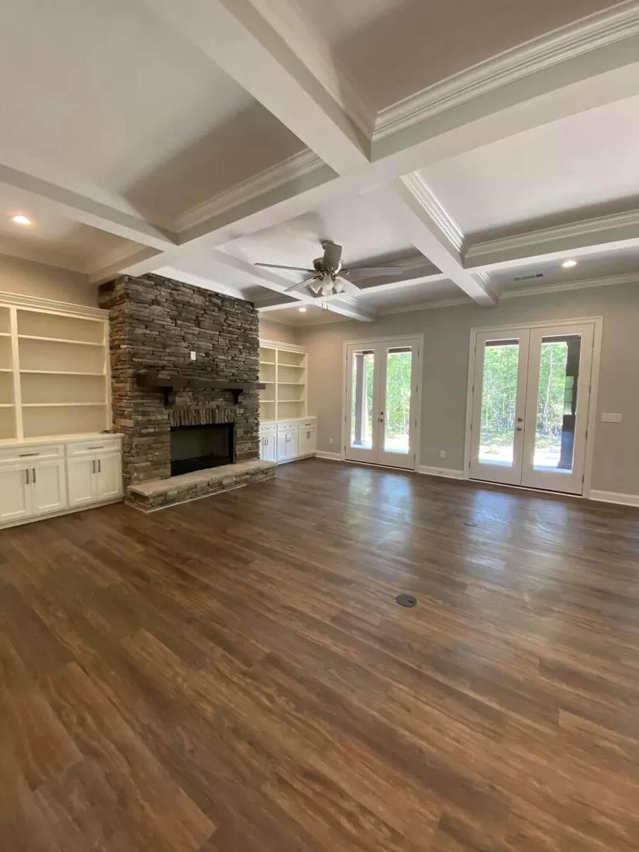 Discover the Cozy Stone Fireplace and Built-In Shelving in This Living Room