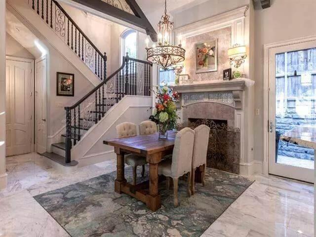 Classic Dining Room with Intricate Wrought Iron Staircase