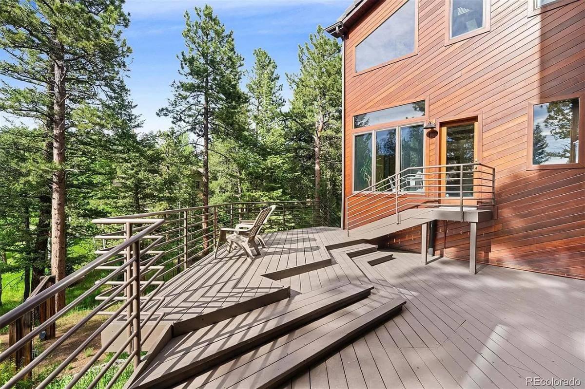 A Wooded Deck with Driftwood Railings Offering a Forest Retreat