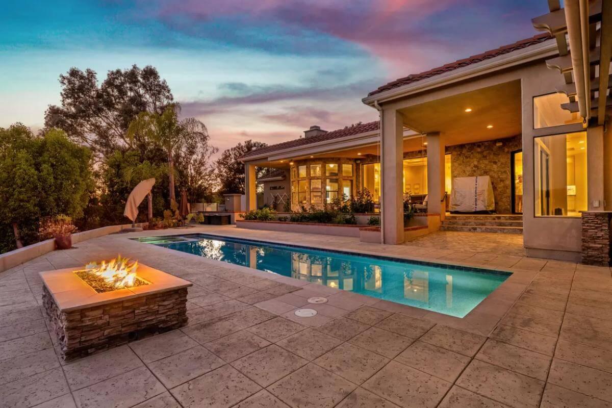 Look at This Backyard Oasis with a Fire Pit by the Pool