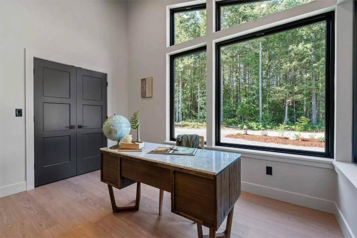 Discover the Tranquility of This Home Office with Forest Views