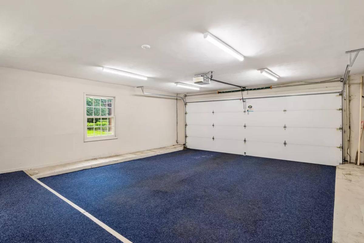 Explore This Spacious Garage with Unique Blue Carpeting