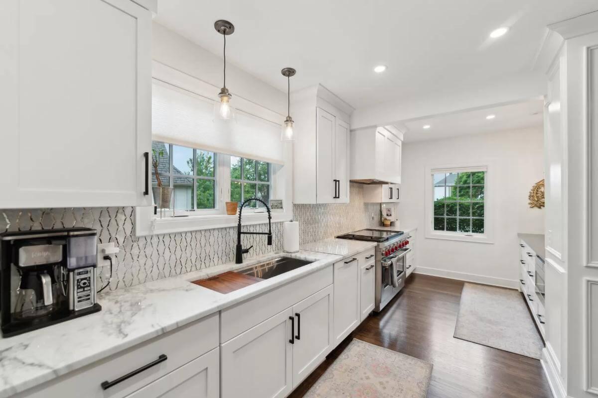 Check Out the Sophisticated Marble Countertops and Unique Backsplash in This Kitchen