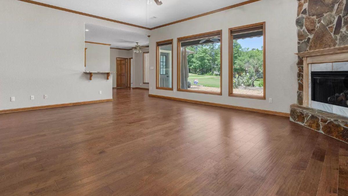 Spacious Living Room with Hardwood Floors and Expansive Windows
