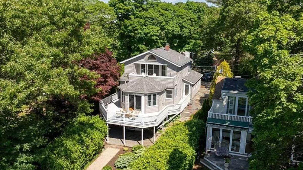 Charming View: Craftsman Home Nestled Amongst Trees with a Wraparound Deck