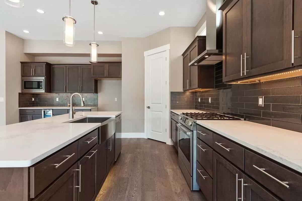 Modern Kitchen with Striking Dark Cabinetry and Subtle Under-Cabinet Lighting