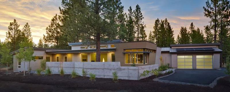 A Modern Facade Nestled in a Forest Setting, Highlighting Expansive Glass Doors