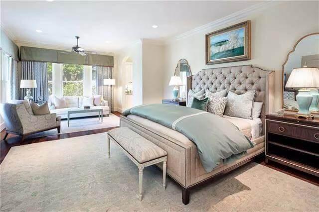 Luxurious Master Suite with Elegant Seating Area and Tranquil Views