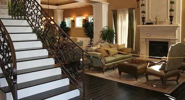 Step Into a Grand Living Room with Ornate Ironwork and Soaring Fireplace