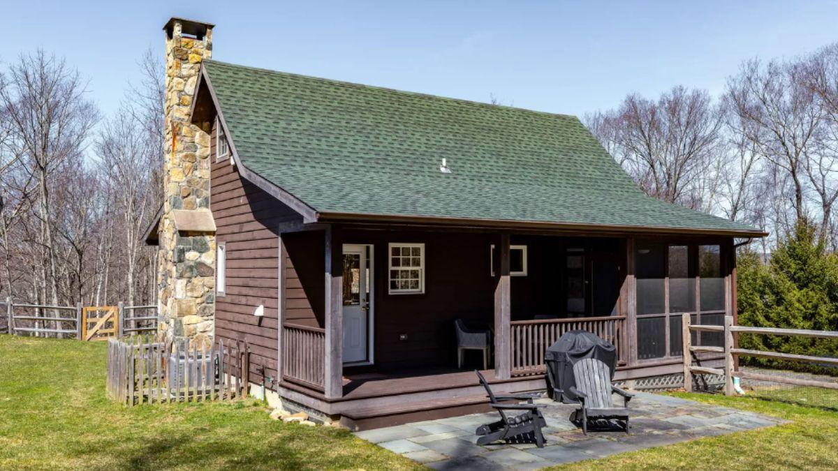 Quaint Cabin with Rustic Stone Chimney and Cozy Porch