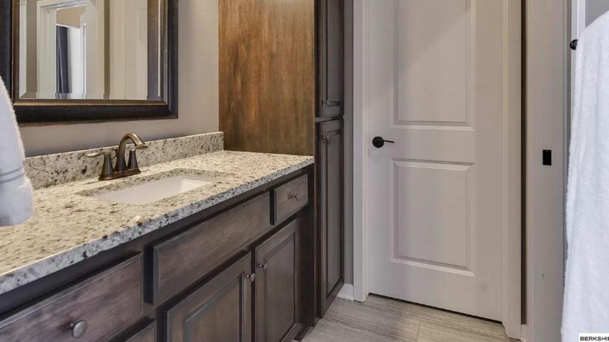 Bathroom Elegance with Granite Vanity Counter and Dark Wood Cabinets
