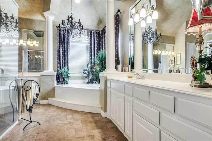 Luxurious Bathroom Retreat with Grand Chandeliers and Classic Columns