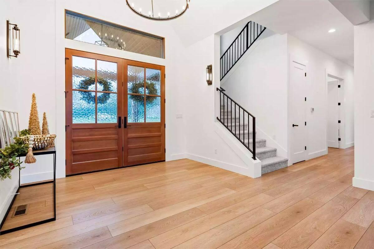 Welcoming Entryway with Bold Wooden Doors and Elegant Metal Railings