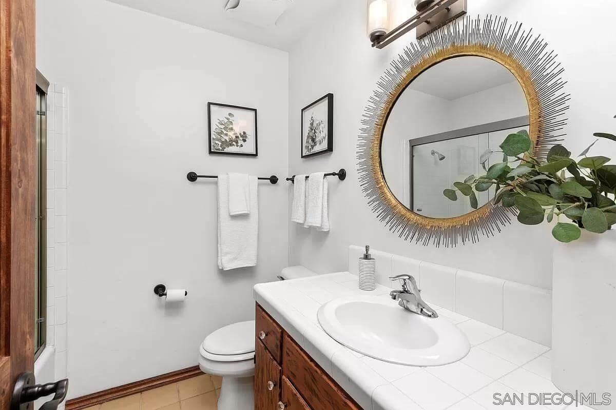 Spot the Sunburst Mirror Adding Flair to This Simple Bathroom
