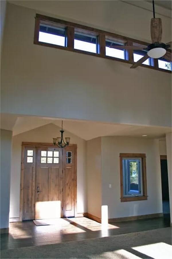 Step Into the Foyer Highlighted by Tall Ceilings and Rustic Woodwork