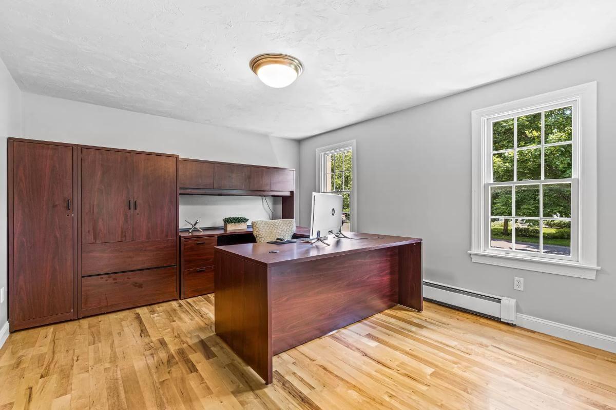Step Into This Bright Home Office with Warm Wooden Built-Ins