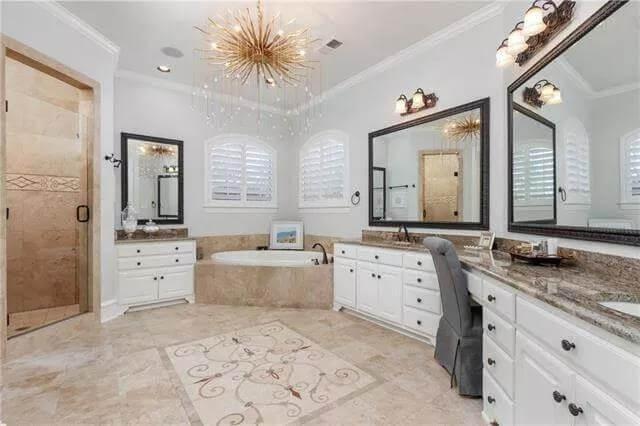Luxuriate in This Bathroom with a Stunning Chandelier and Tub Niche