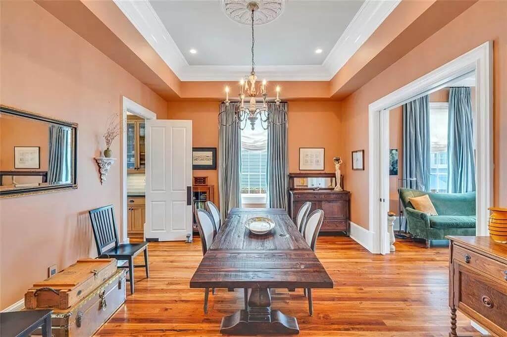 Explore This Dining Room with Warm Peach Walls and Vintage Decor