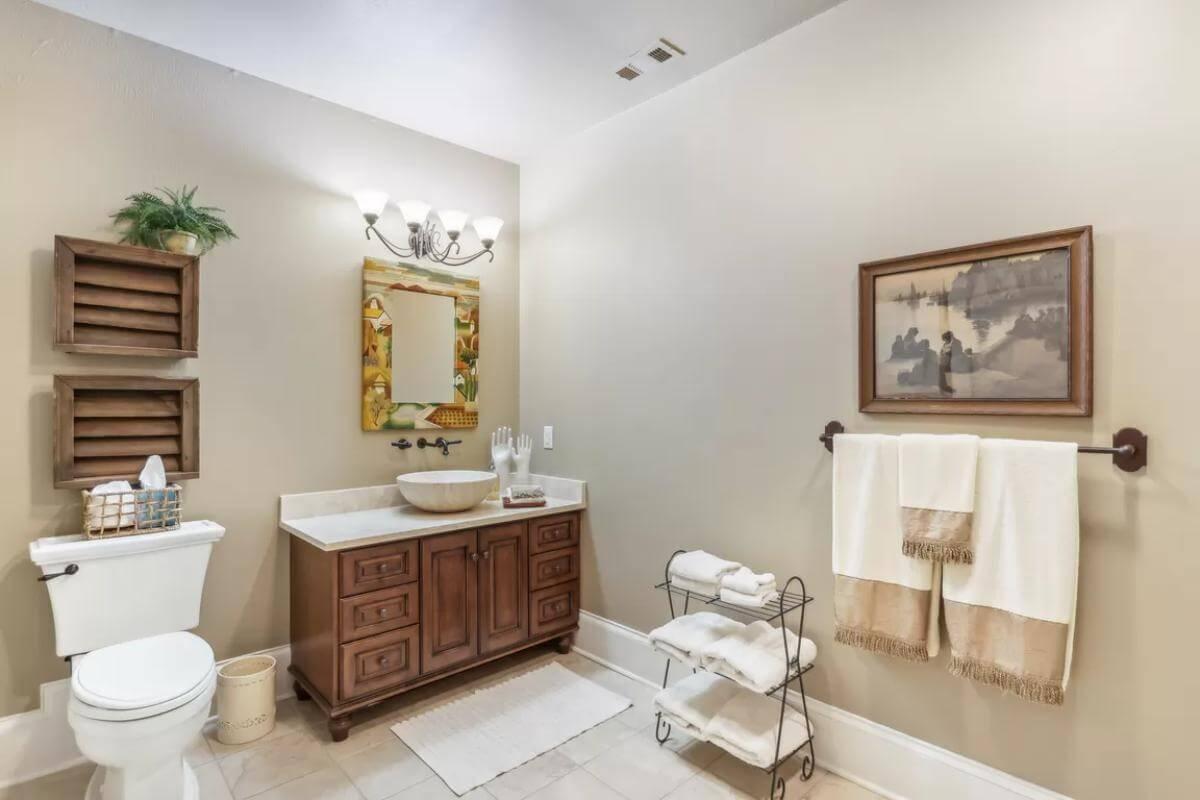 Rustic Bathroom with Wooden Vanity and Artful Details