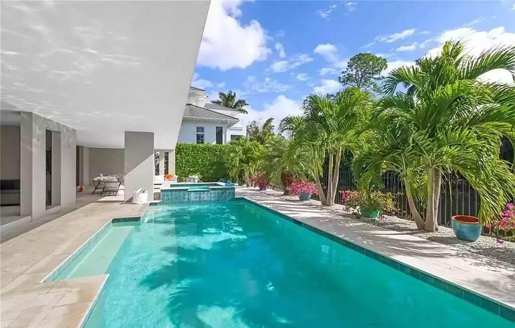 Enjoy Shade and Sun by This Pristine Pool with Lush Palms