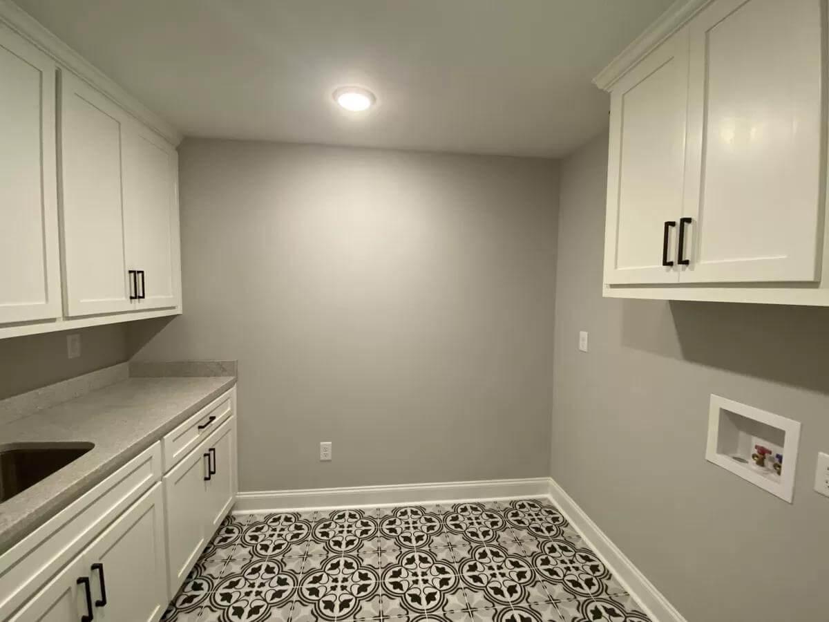 Sleek Laundry Room with Eye-Catching Patterned Tile Flooring