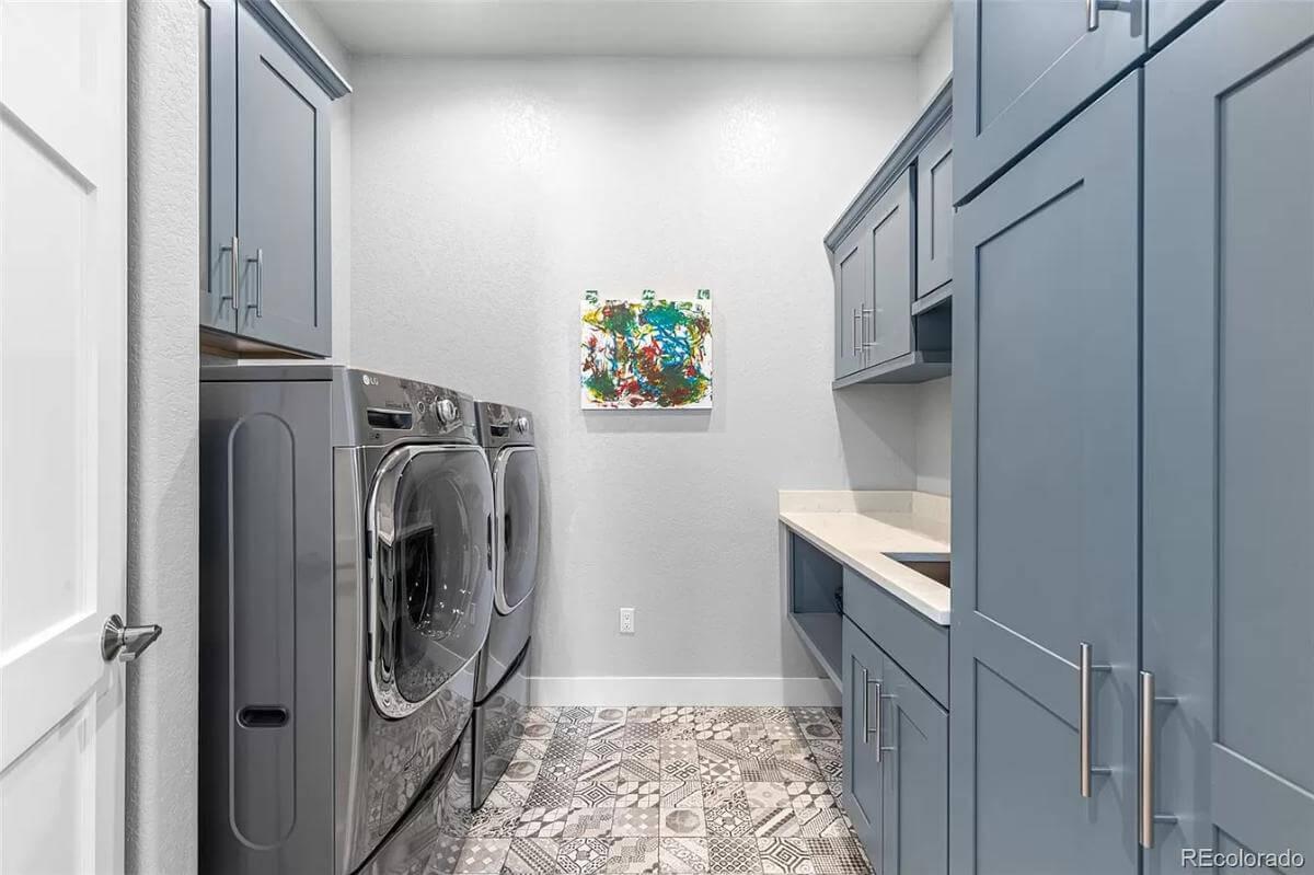 Notice the Stylish Blue Cabinetry in This Practical Laundry Room