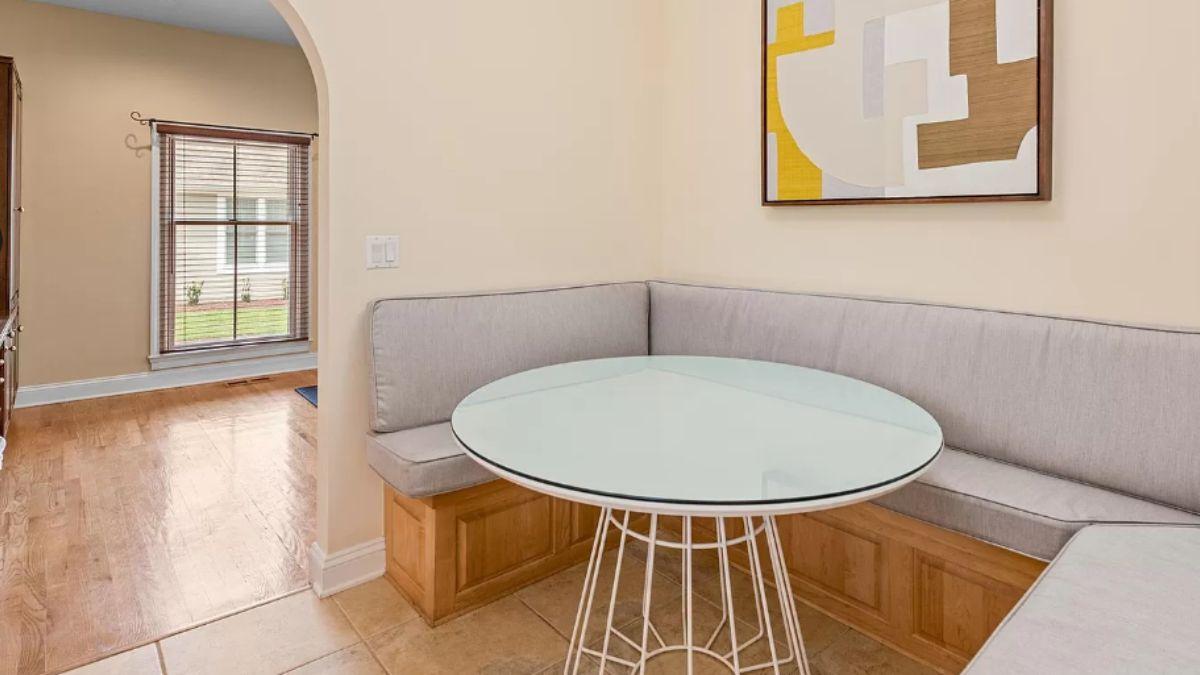 Cozy Breakfast Nook with a Glass Table and Built-In Seating