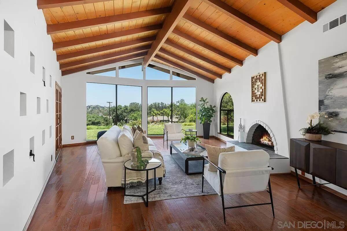 Admire the Vaulted Ceilings and Panoramic Views in This Living Room