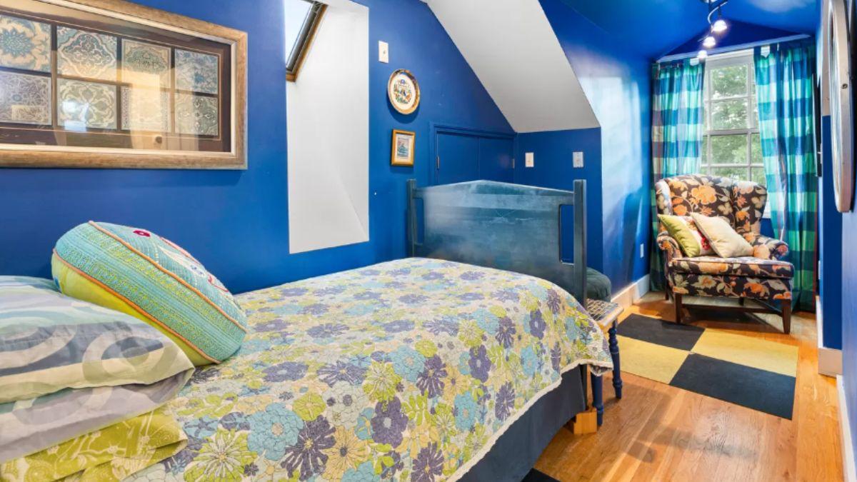 Dive into This Blue-Hued Attic Bedroom with a Fun Floral Twist