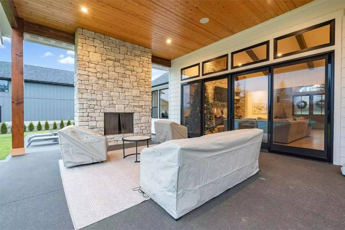 Outdoor Comfort with a Striking Stone Fireplace