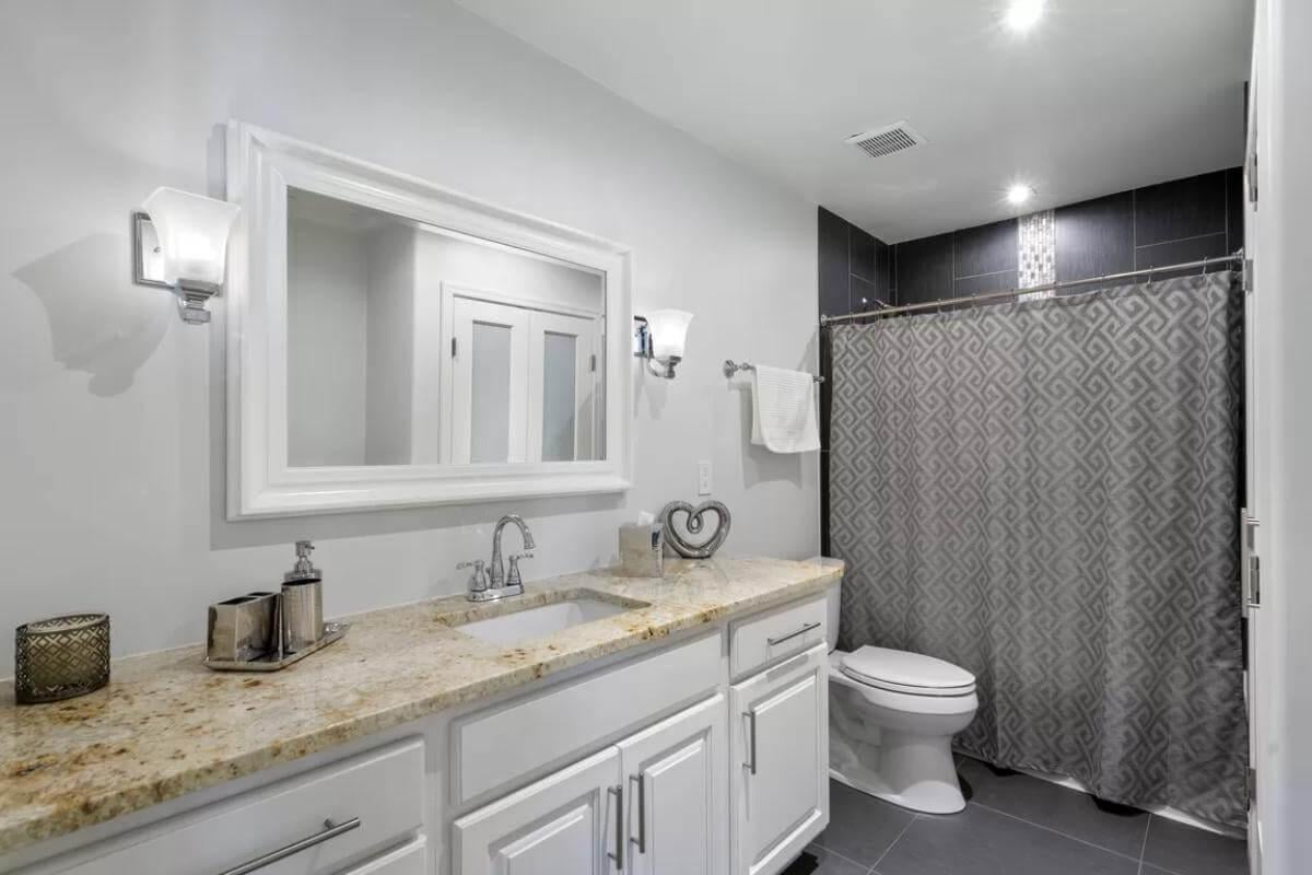 Check Out the Granite Countertop in This Bright Bathroom
