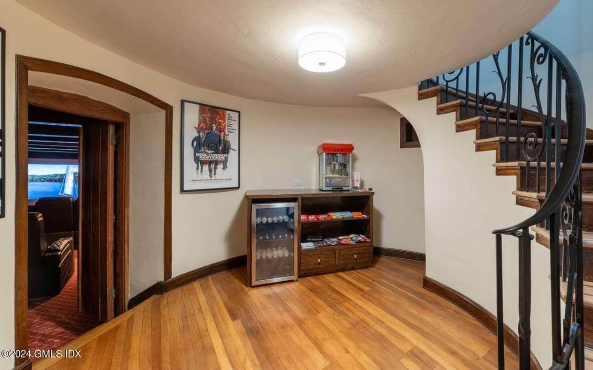 Step into the Movie Room with This Popcorn Station Under the Curved Staircase