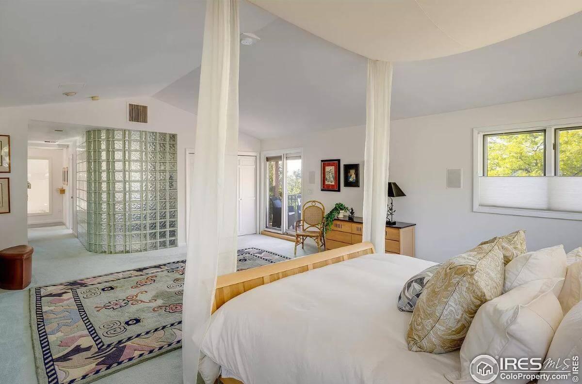 Relax in This Sunlit Bedroom with Glass Block Accent Wall