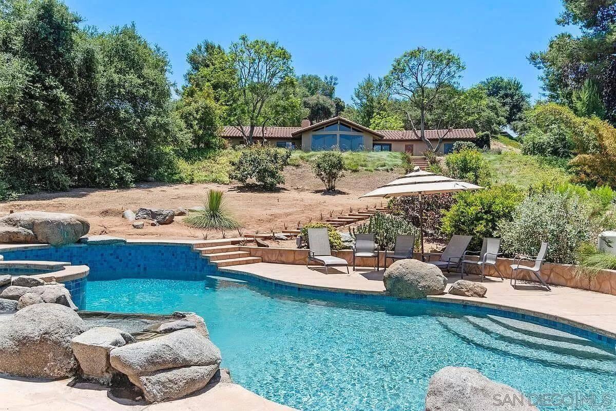Relax by This Pool with Natural Stone Features and Lush Surroundings