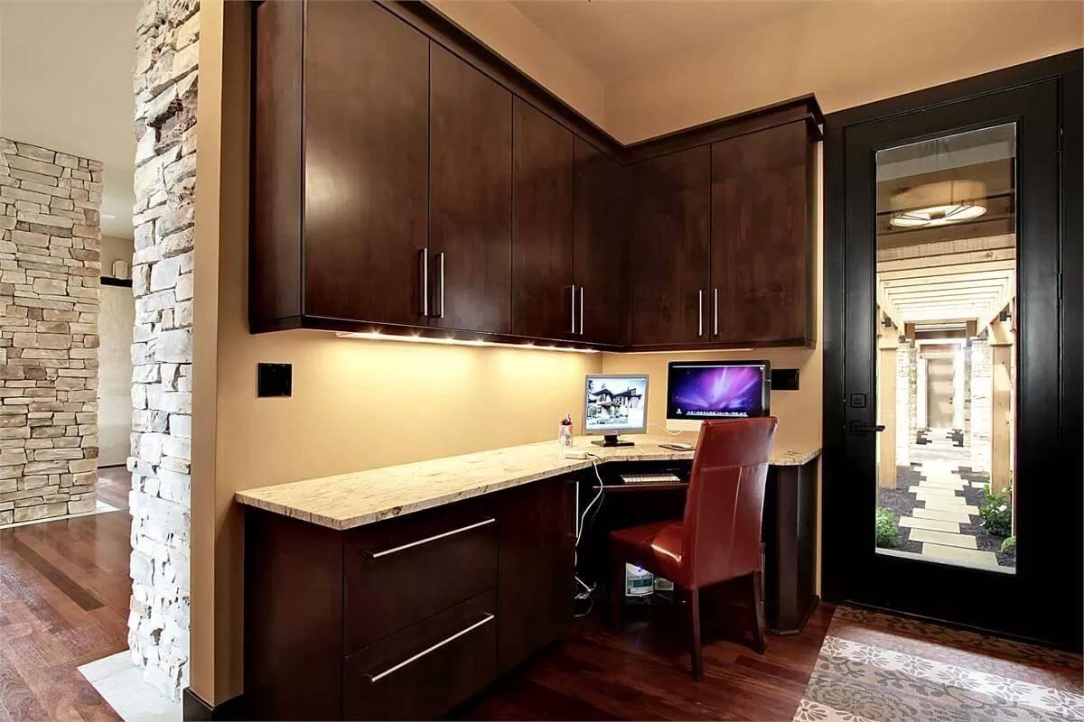 Compact Home Office with Stone Accents and Glowing Under-Cabinet Lighting