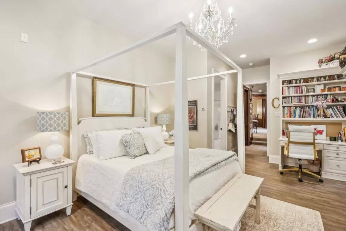 Chic Bedroom with a Four-Poster Bed and Handy Workspace