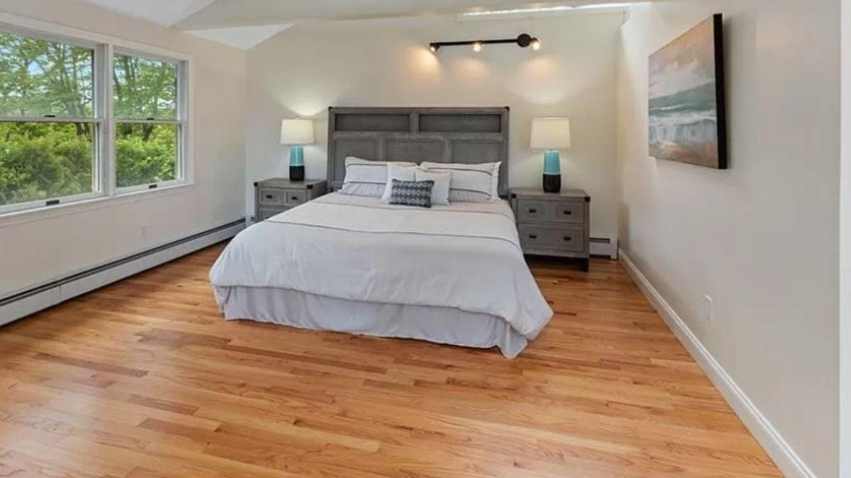Bright Primary Bedroom with Track Lighting and Hardwood Floors