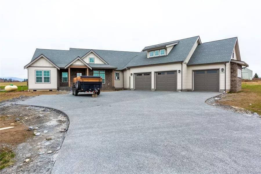 Expansive Driveway and Triple Garage in This Traditional Craftsman Exterior