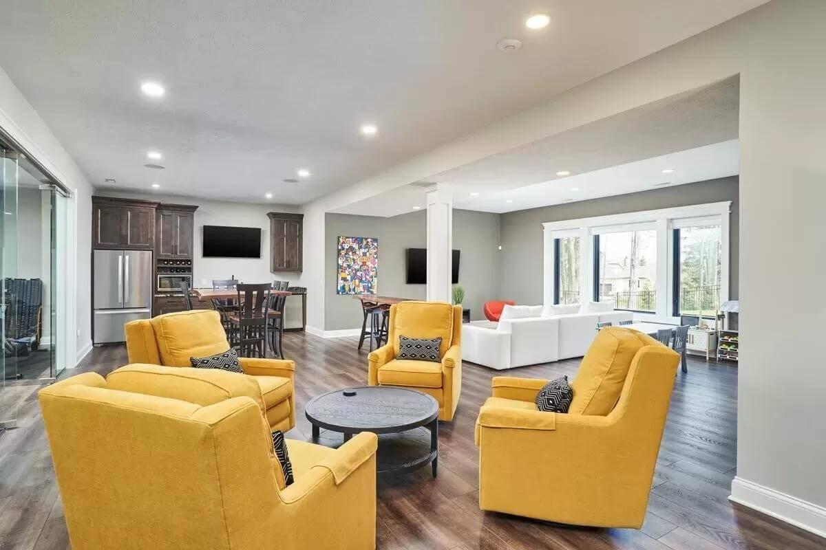 Vibrant Family Room with Bold Yellow Seating and Floor-to-Ceiling Windows