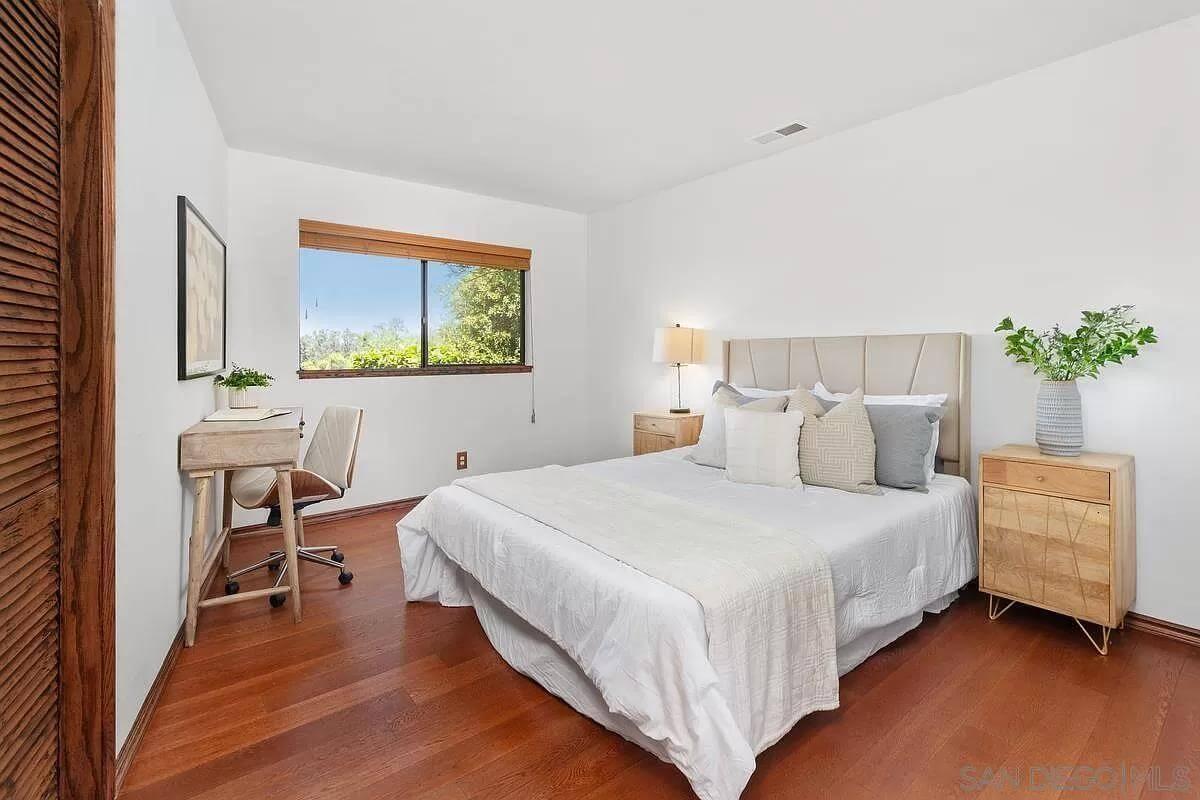 Appreciate the Simplicity and Warmth in This Bedroom With a Tranquil View