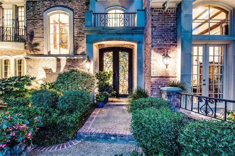 Step Inside Through These Ornate Iron Doors Framed by Classic Brickwork