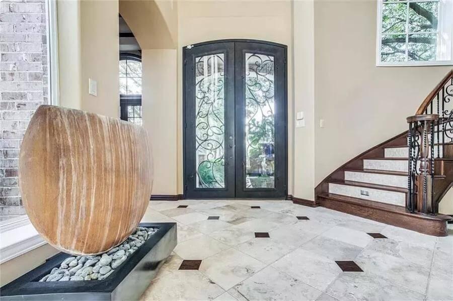 Step Into This Grand Entrance with Ornate Iron Doors and a Graceful Staircase