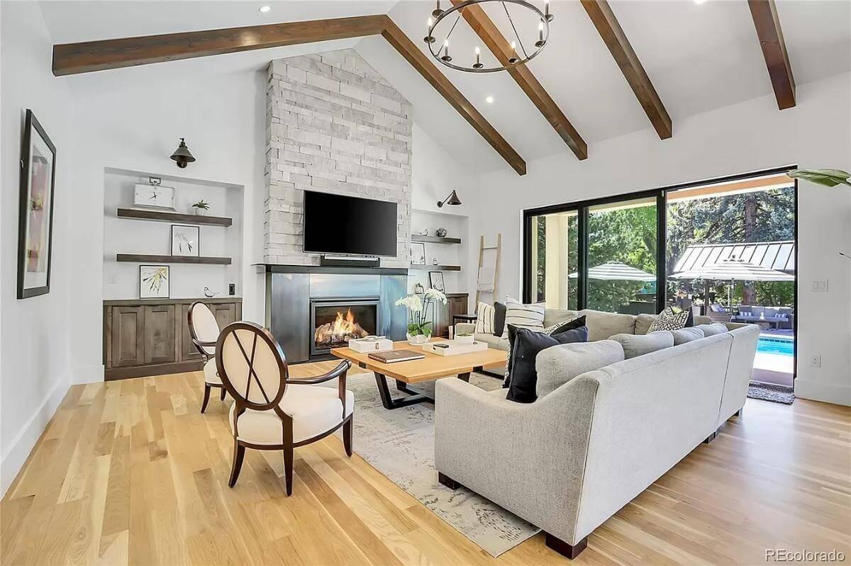 Take In the Vaulted Ceilings and Stone Fireplace in This Inviting Living Room